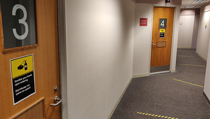 On each floor and outside public spaces including, hearing rooms, there are hand washing signs and 2-metre physical distancing markings along the corridor floor. 